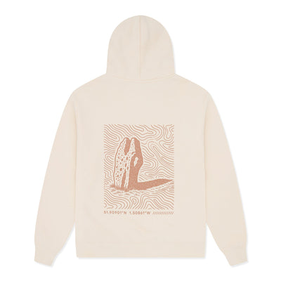 Beige hoodie with a graphic design on the back against.