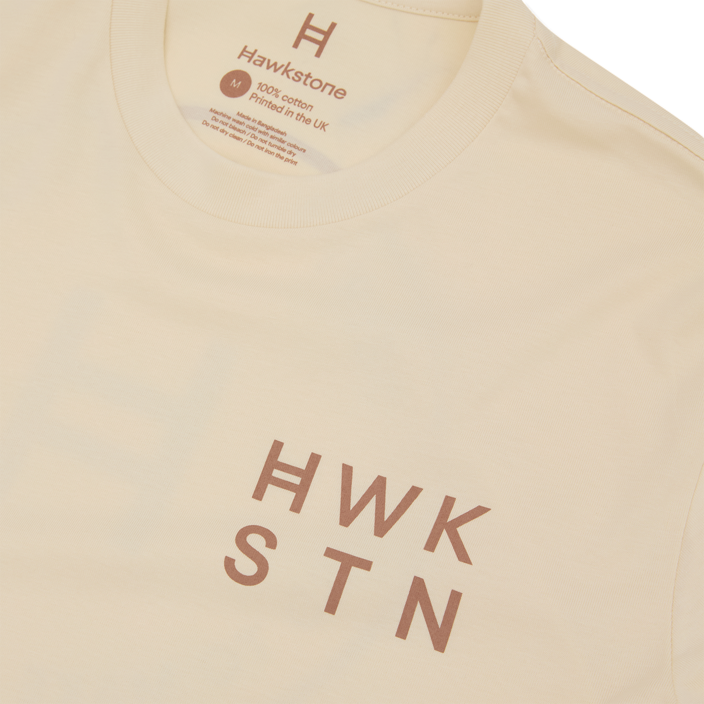 Ecru t-shirt with 'Hawkstone' branding and text on a white background 