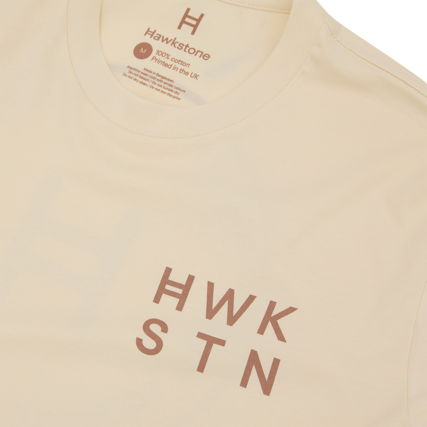 Ecru t-shirt with 'Hawkstone' branding and text on a white background