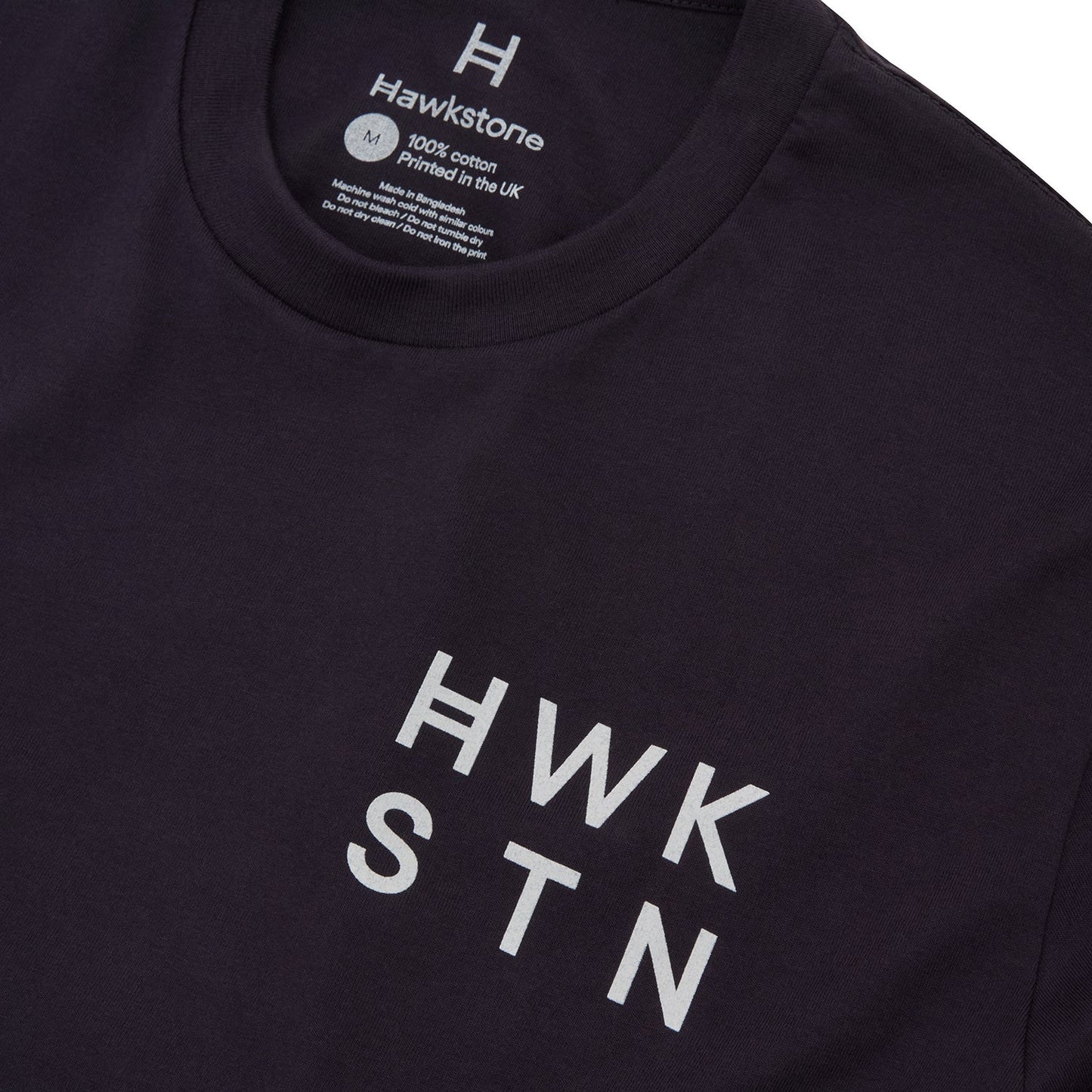Ink blue t-shirt with 'HWK STN' text and Hawstone branding on a white background 