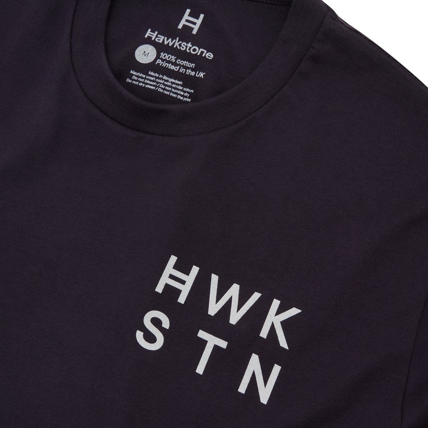 Ink blue t-shirt with 'HWK STN' text and Hawstone branding on a white background