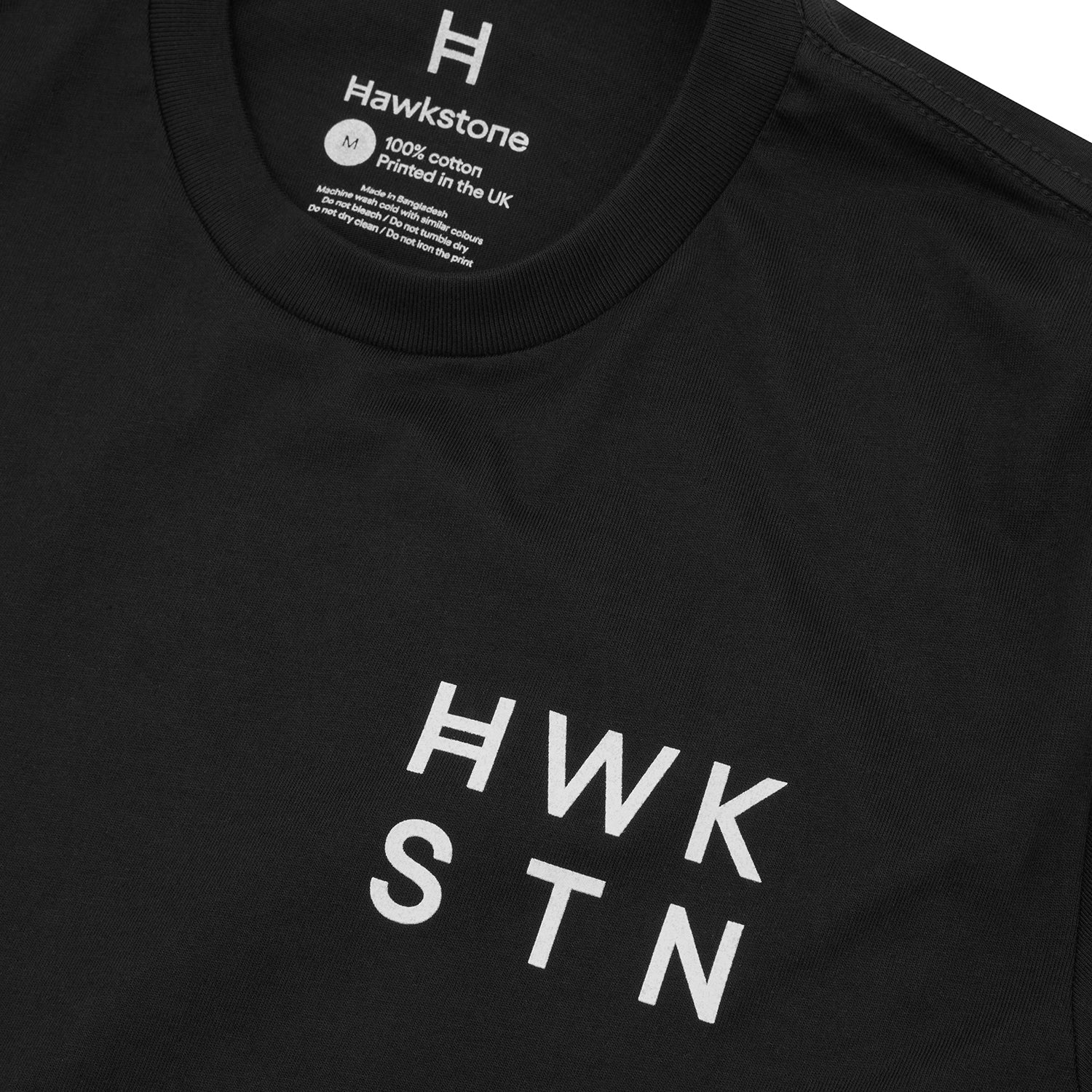 Black t-shirt with 'HWK STN' printed on it, featuring the brand 'Hawkstone'.